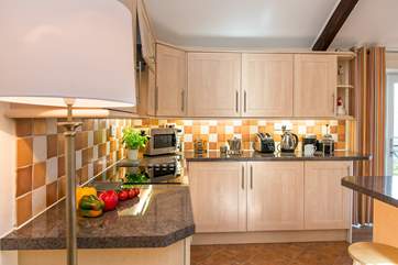 The delightful kitchen has all you need to cook up a treat.