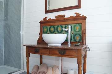 In the cabin, a beautiful late Victorian wash stand has been updated with a contemporary basin and hot and cold running water.