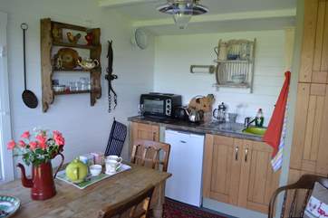 The kitchen and dining area of the cabin where modern facilities mix with lovely antique finds.