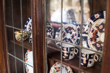 Vintage china adorns the cupboards.
