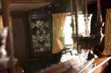 Large windows and mirrors add light to the room.