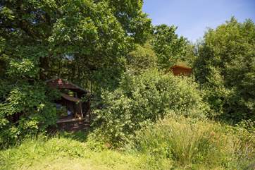 You can see the safari tent to the left and the cabin to the right in the photograph, overlooking the lake.