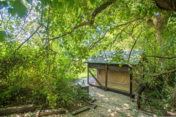 From the cabin, steps lead down to the romantic safari tent overlooking the lake.