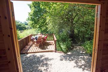 Double doors open onto a deck area, perfect for al fresco dining overlooking the lake.