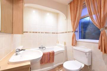 The ensuite bathroom has a bath and a separate shower cubicle.