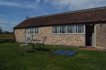 The door to one of the bedrooms opens out onto the lawned enclosed garden too.