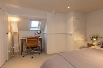There is space in the bedroom for this little desk/dressing table.