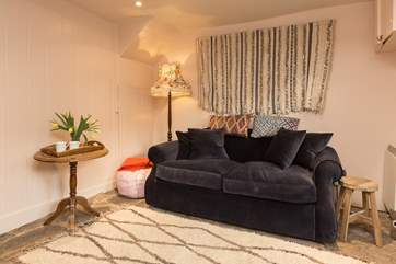 There is a deep squishy sofa to sink into for a snug evening in.