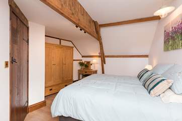 Another view of this bedroom which has kept the lovely character of the original barn, with exposed beams - mind your head on the one closest to the bed!