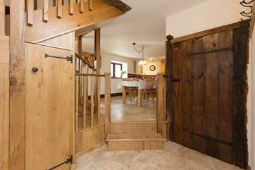 This is the entrance hallway. The cloakroom is through the door to the right and a couple of steps take you up to the kitchen/dining area.