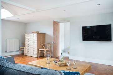 The TV area has a big wall-mounted TV and DVD player.