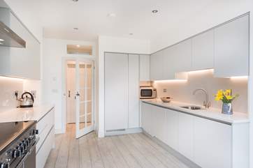 Smooth, pared back lines in the kitchen-area with handleless unit doors.
