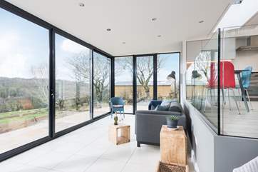 The split-level design ensures the sitting-area has wonderful views over the meadow and countryside beyond.