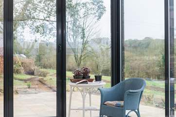 Doors open on all sides of the contemporary extension.