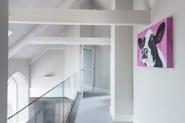 The gallery overlooks the sitting/dining-room below and leads to Bedrooms 3 and 4.