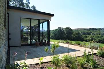 Looking across the terrace to the meadow and countryside beyond.