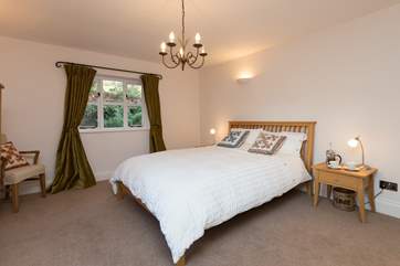 The ground floor bedroom (1) with its king-size bed is so spacious. Dual-aspect with views over the gardens to the front and to the grounds at the back too.
