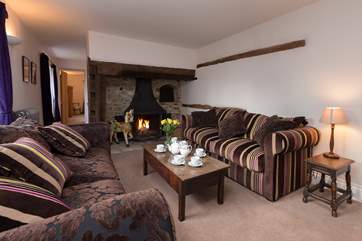 Another view of this sitting-room with its deep three-seater sofas. There is comfy seating for all.