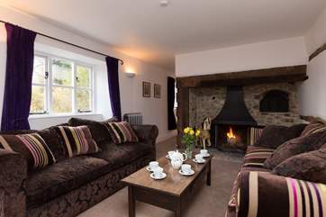 This is the main sitting-room with its inglenook fireplace and wood-burning stove. beyond is the playroom/snug and the ground floor bedroom.