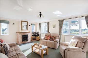 The spacious sitting-room with comfy reclining sofas and chairs for relaxing after a busy day out.