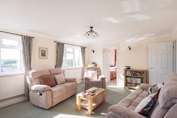 The spacious sitting-room with the smaller twin bedroom to the rear.
