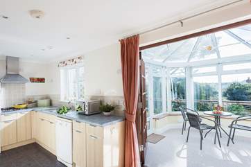 Looking through from the dining-area to the conservatory and kitchen-area.