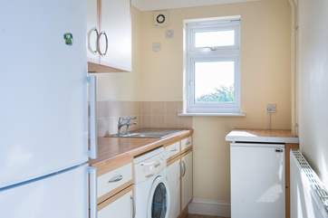The useful utility-room with washing machine, tumble-drier, fridge, freezer and somewhere to store the coats and boots.