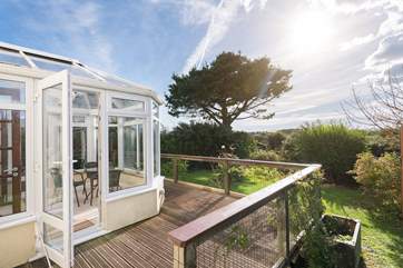 The conservatory and decking overlook the pretty garden.