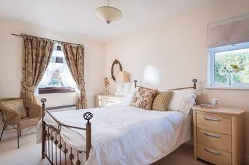 The pretty double bedroom is to the front of the bungalow.