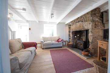 The sitting-area has a roaring wood-burner.