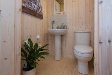 At the back of the tent is the en suite cloakroom with proper flushing toilet and wash-basin.