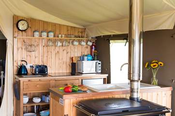 The kitchen-area is fully equipped and includes a four ring hob, fridge/freezer, microwave, toaster and kettle! There is also the log-fired range to cook on too.