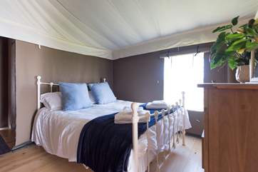 The comfortable king-size bed in Bedroom 1.