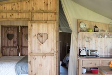 The gorgeous cabin bed to the left and kitchen-area to the right.