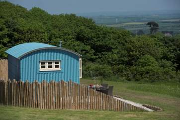 The hot tub sits behind the fence for privacy and shelter and just like the hut looks straight out to sea.