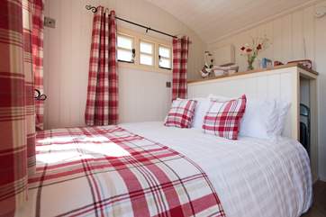 The comfortable king-size bed looks straight out to sea.