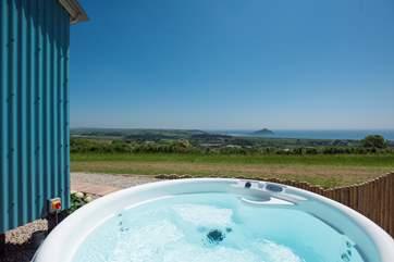 The hot tub is private and sheltered and has the same stunning views.