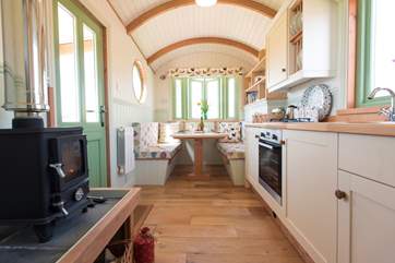The light and airy wagon, looking past the kitchen to the dining-area (the seats fold down with ease to become the second double bed).
