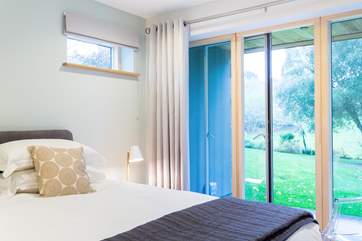 The ground floor has floor to ceiling glass doors