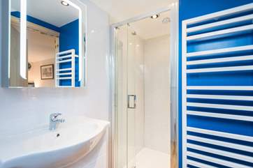 The en suite shower cubicle is larger than the standard size.