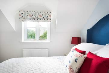 Bedroom 2 overlooks the rear patio garden.