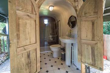 The spacious shower and toilet are behind the tent, with an overhead canopy.