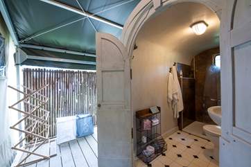 The spacious shower and toilet are behind the tent, with an overhead canopy.