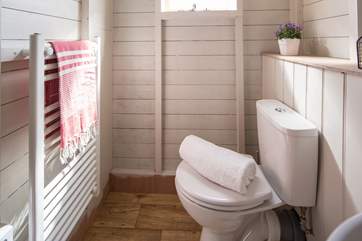 There is a flushing loo and also a heated towel rail to keep you snug.