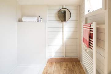 The shower-room has a glass screen and a heated towel rail for warm fluffy towels.