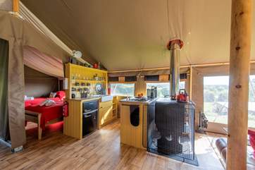 A fully fitted gorgeous kitchen-area with wood-fired range, two ring gas hob and fridge/freezer for your glamping holiday luxuries.