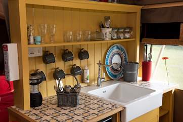 The kitchen area is well-equipped for your glamping needs.
