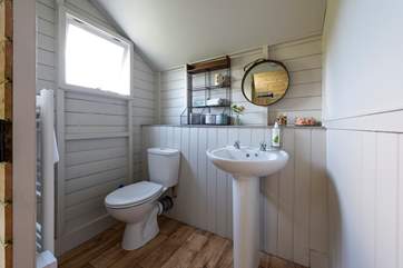 The cloak-room is at the back of the tent and catches the morning sunshine.