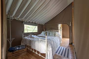 The super-comfy double bed awaits you after a day of being on holiday, the shower room and cloak room are through the door at the back of the tent.