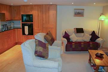 The sitting-room has comfortable seating and is centered in front of the TV.